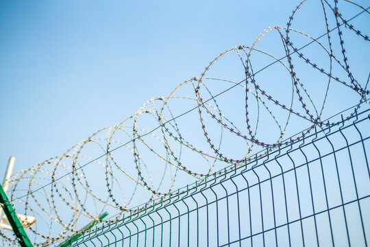 the barbed wire fence of protected prison territory