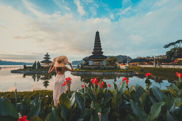 Beautiful girl visiting the ulun danu bratan temple in Bali. Concept about exotic lifestyle...
