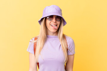 young blonde woman with cheerful and rebellious attitude, joking and sticking tongue out. summer...