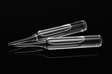 Medical ampoules for injection on dark background. Medicines and disease treatment, pharmacology and science concepts