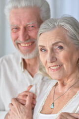 senior couple hugging at home