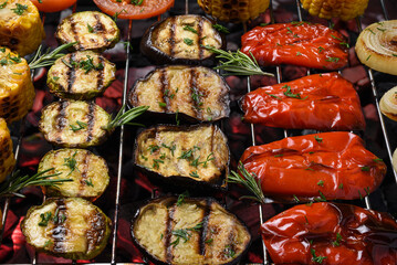 Vegetables (corn, zucchini, eggplant, sweet pepper, tomato and onion) are prepared on a grill. Vegetables grilled. Close-up.