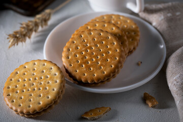 Cookies in a white saucer on a light table