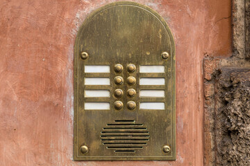 Vintage metal intercom on an old brown painted wall - 433439140