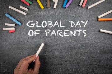 Global Day of Parents 1 June. Many colored pieces of chalk on a black chalkboard