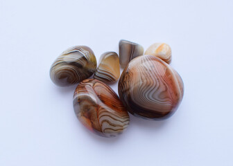 Multicolored gemstones, tumbled minerals. Agates of various sizes. Bostwan agate