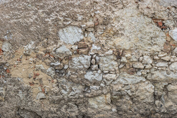 Old stone masonry with weathered lime plaster