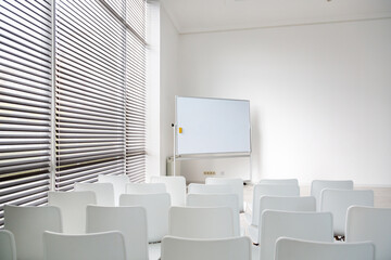 Meeting room with a large white school board and white chairs. Nice spacious room in a modern light office..