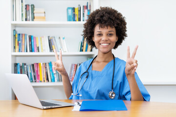 Laughing and motivated afro american nurse or doctor at work