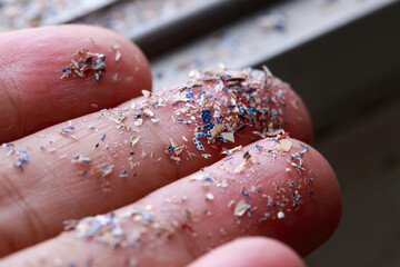 Close up side shot of microplastics lay on people hand.Concept of water pollution and global...