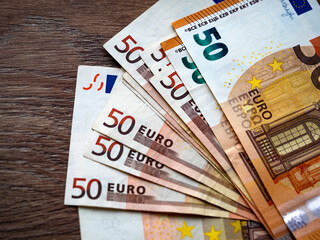 In this photo illustration, a collection of fifty Euro banknotes are seen displayed.