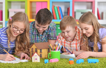 Group of children drawing with pencils