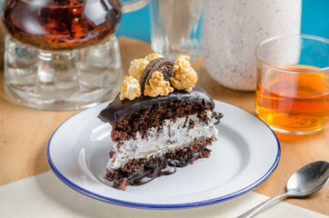 A piece of vegan cake with chocolate and a delicate white cream.