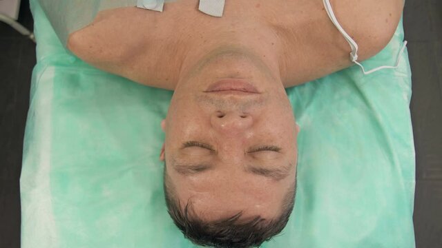 Unconscious middle-aged patient regained consciousness. Postoperative period, coma, complications after coronavirus.
