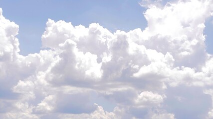 Fluffy  cloudscape against blue sky shaped like animal.