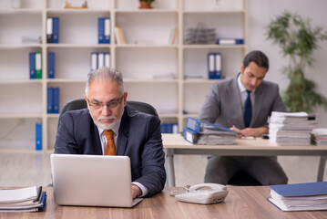 Two employees sitting at workplace