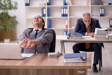 Two employees sitting at workplace