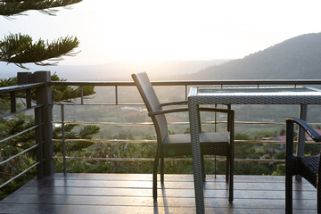 Tables and chairs in the cafe overlooking the mountain scenery. And sunset