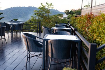 Tables and chairs in the cafe overlooking the mountain scenery. And sunset
