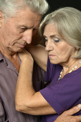 Portrait of sad senior couple posing at home
