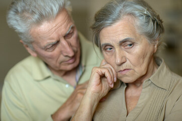 Portrait of sick  elderly woman and man  at home