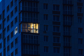 the light burns in one window of the multitude in a multi-storey residential building - Powered by Adobe