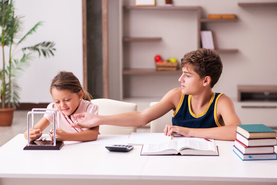 Schoolboy and his small sister staying at home during pandemic