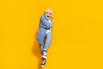 Fototapeta premium Full length photo of happy positive old man smile good mood dancer funky isolated on yellow color background