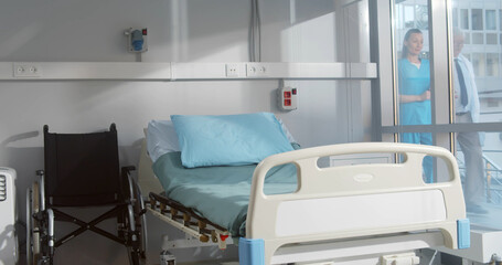 Empty bed and wheelchair n modern hospital room