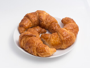 3 croissants on a white plate