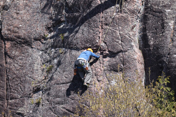 Rock Climber going up rock face in Northern Ontario
