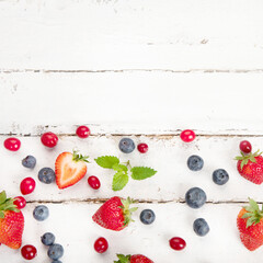 Naklejka na ściany i meble Various fresh forest berries on white background. Organic food concept.