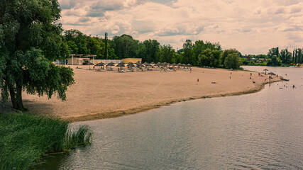 Fototapeta na wymiar Beaches on the banks of the Khorol River in Myrgorod{Mirgorod} resort and a park area.