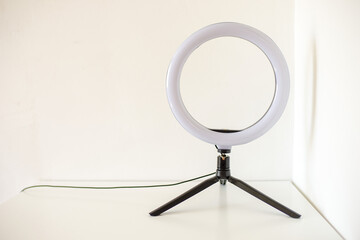 New ring lamp on tripod on white table