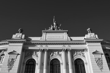 Facade top of the main building of Warsaw University of Technology in black and white