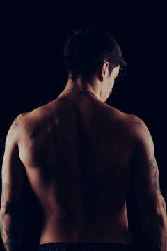 back of a young man with tattoos