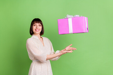 Profile side photo of young girl happy positive smile fly air fall catch present box birthday isolated over green color background