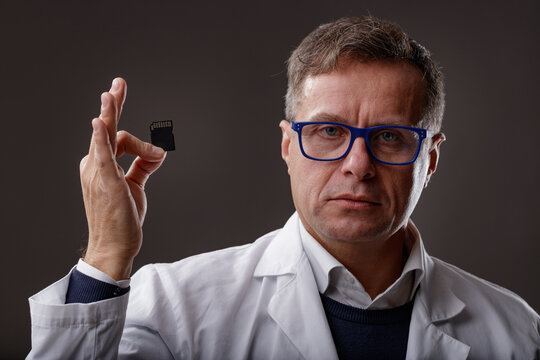 Scientist Or Forensics Expert Holding Up An SD Card