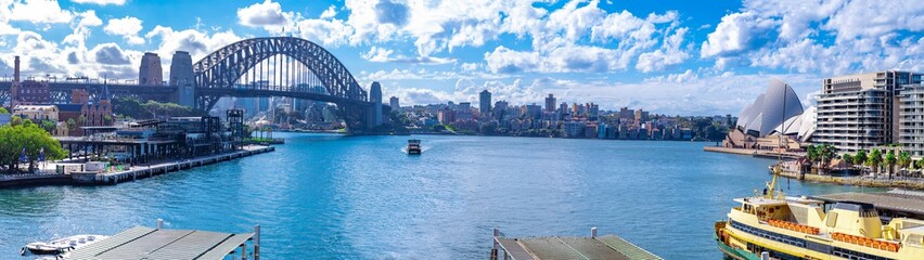 Naklejka premium Panorama view of Sydney Harbour and buildings bridges ferries. Picture taken from Cahill Expressway Circular Quay NSW Australia