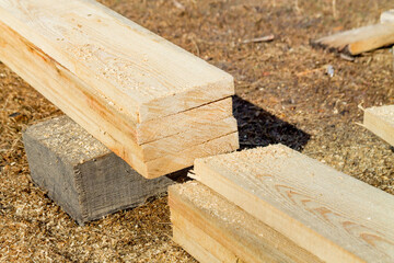 Wooden building materials: cut wood boards on a construction site