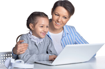 Emotional mother and daughter using laptop