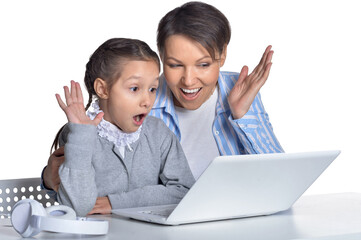 Emotional mother and daughter using laptop
