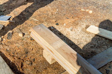 Wooden building materials: cut wood boards on a construction site