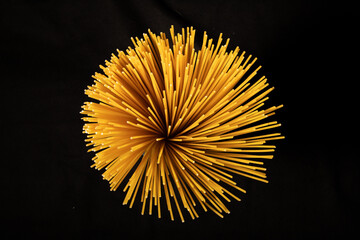 close-up of spaghetti pasta, shot from above, black background