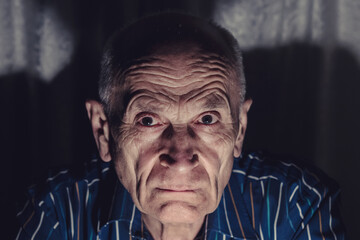 Headshot large scale portraiture of aged angry man with wrinkled face