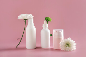 Mock up natural cosmetics: serum, cream, mask for advertising on light pink background with flowers. Organic products.