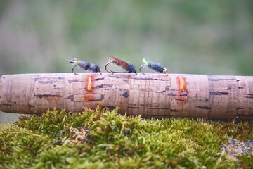 Fly box and rod on the river bank. Fly fishing.