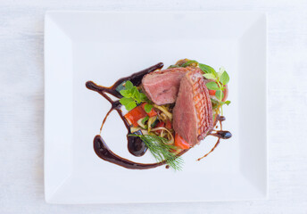 Grilled Duck served on a plate with vegetables in restaurant