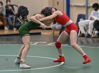 Female High School wrestlers competing at a wrestling meet