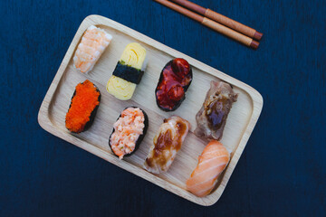 Zushi set is a Japanese dish that is placed on a wooden plate to add beauty to it even more.